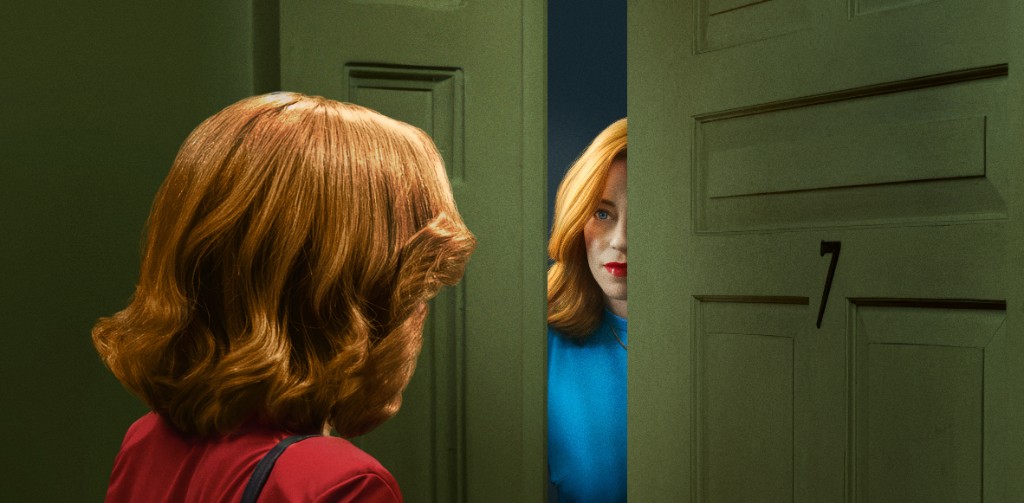 DreamQuil theatrical key art. A woman in red faces a red-haired double in a blue dress, looking through a green doorway.